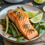 Teriyaki salmon served with rice and broccoli on a wooden table