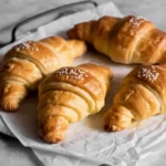 Croissant recipes fresh from oven on wooden table